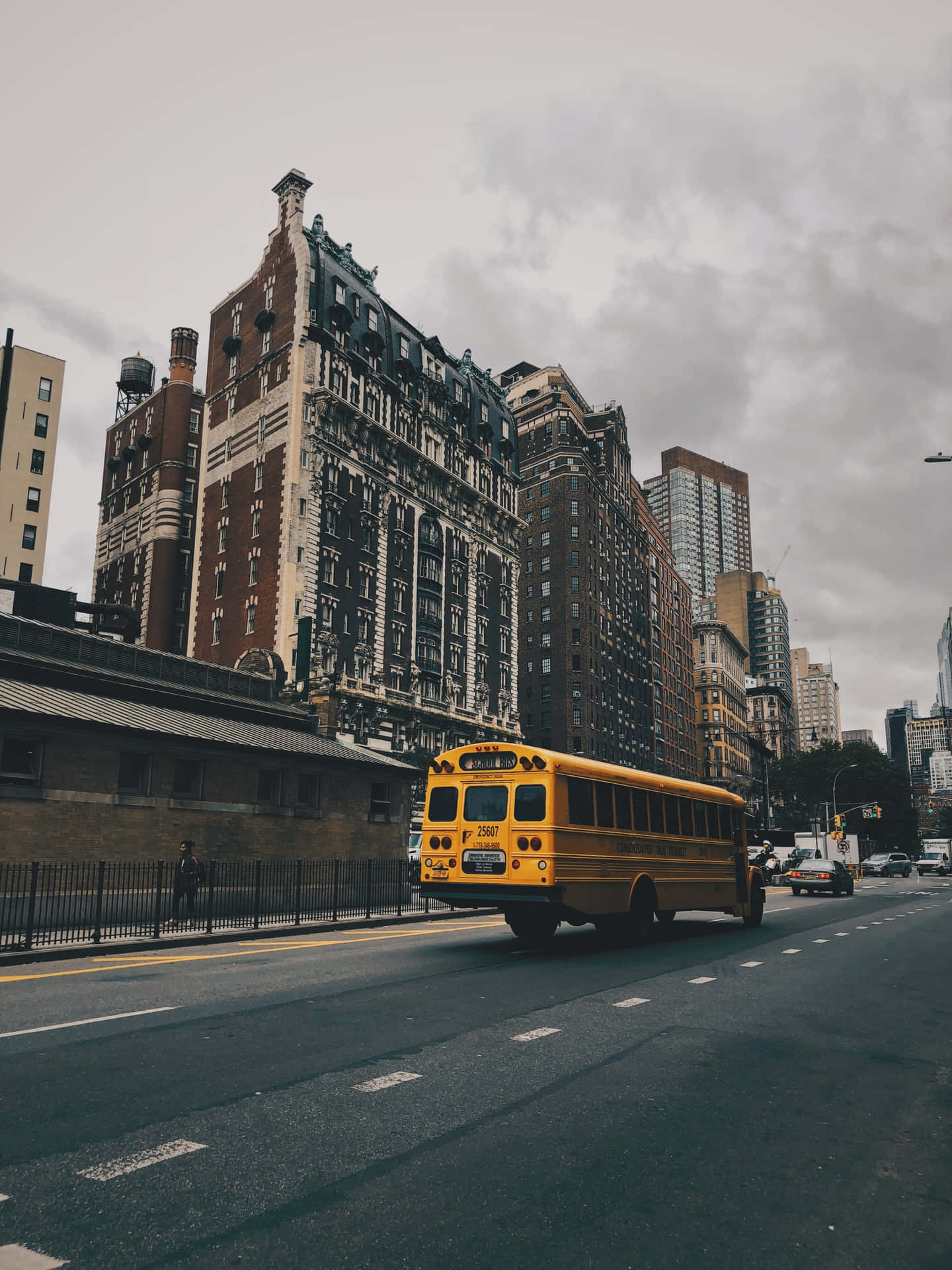 School Bus Against Tall Buildings Background