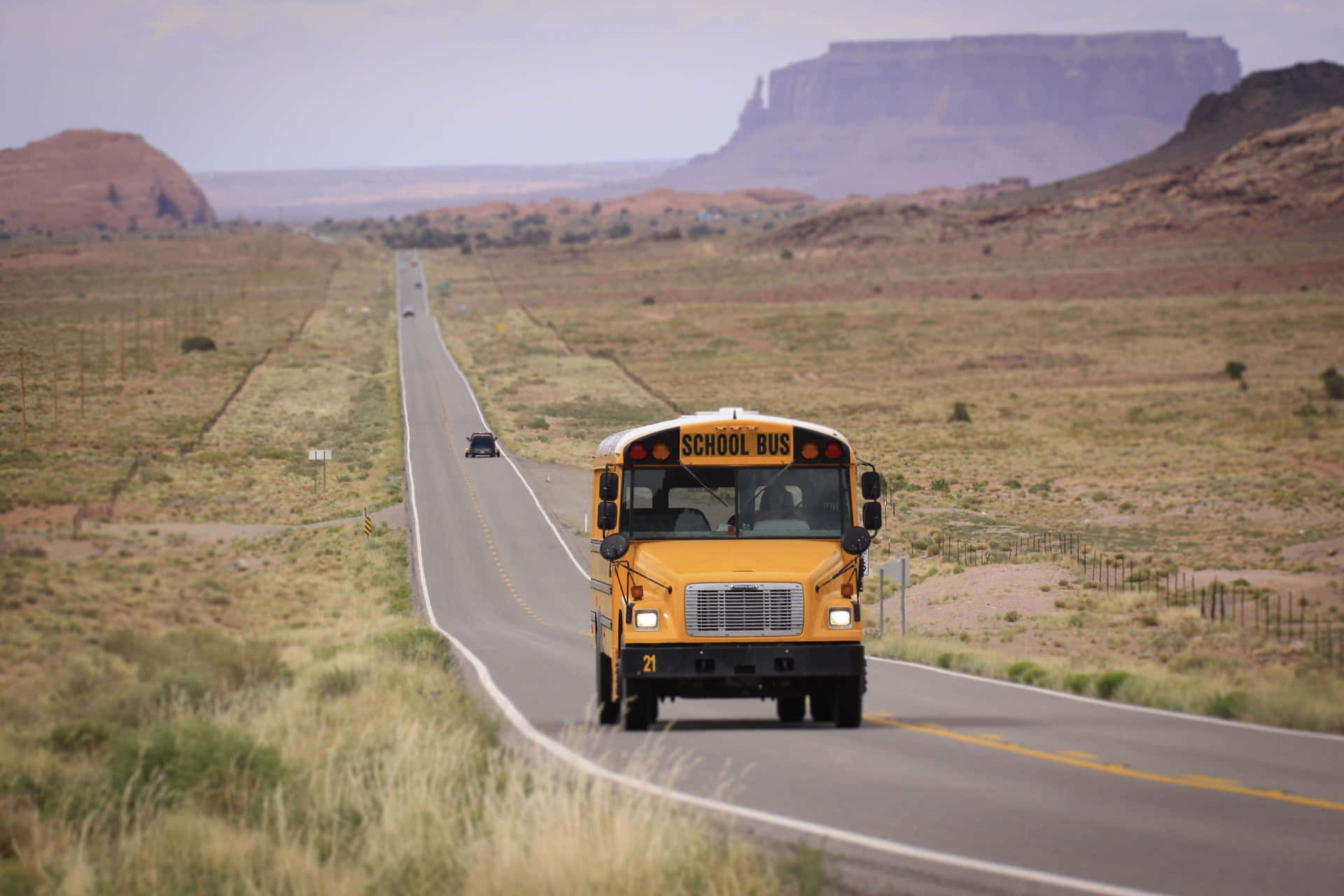 School Bus On Long Rural Road Background