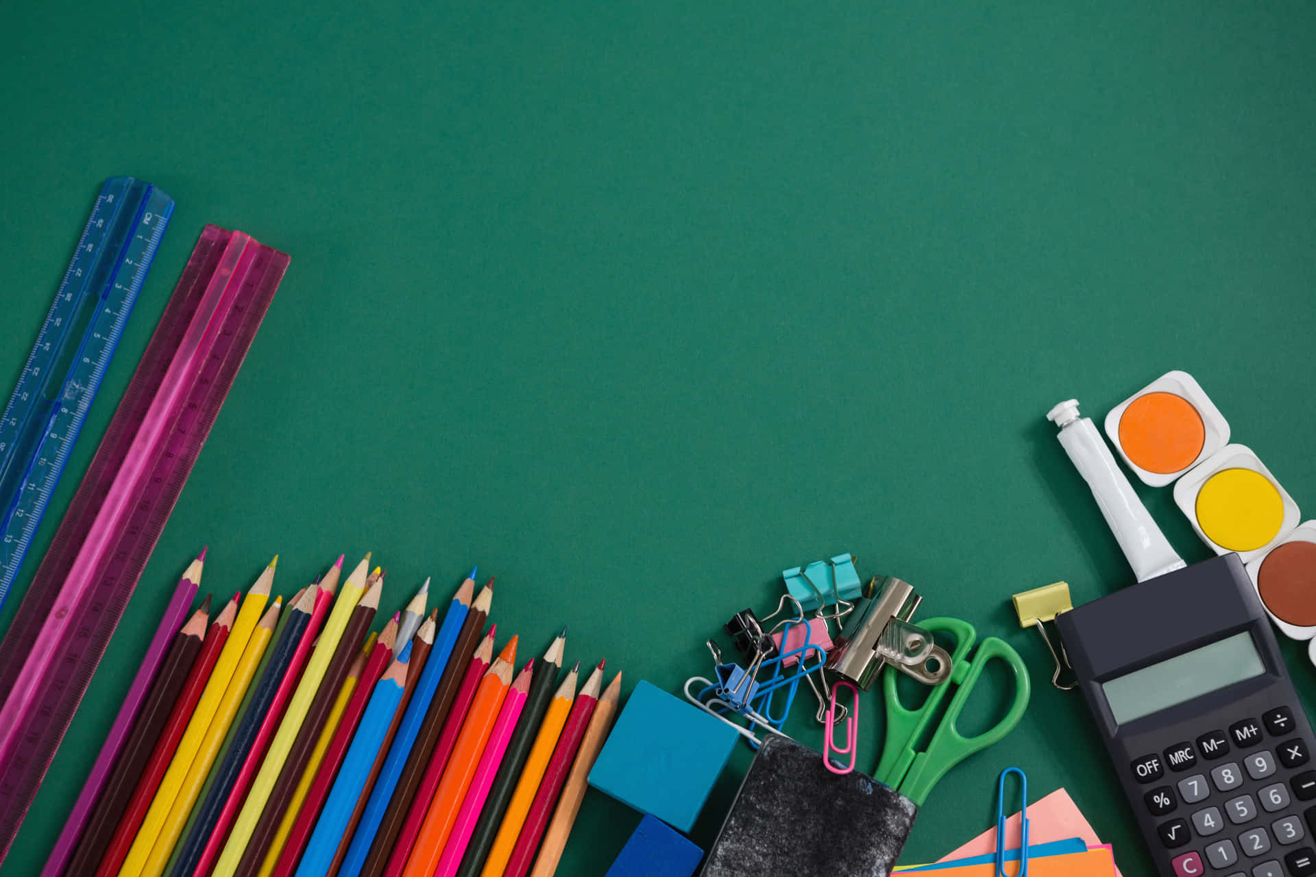 School Supplies On A Green Background