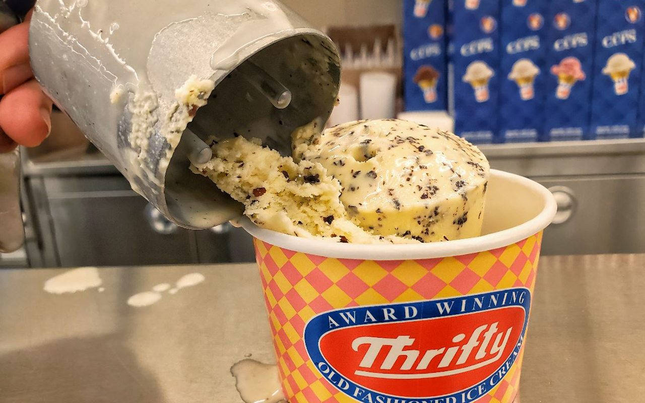 Scooping Thrifty Ice Cream Into Cup Background