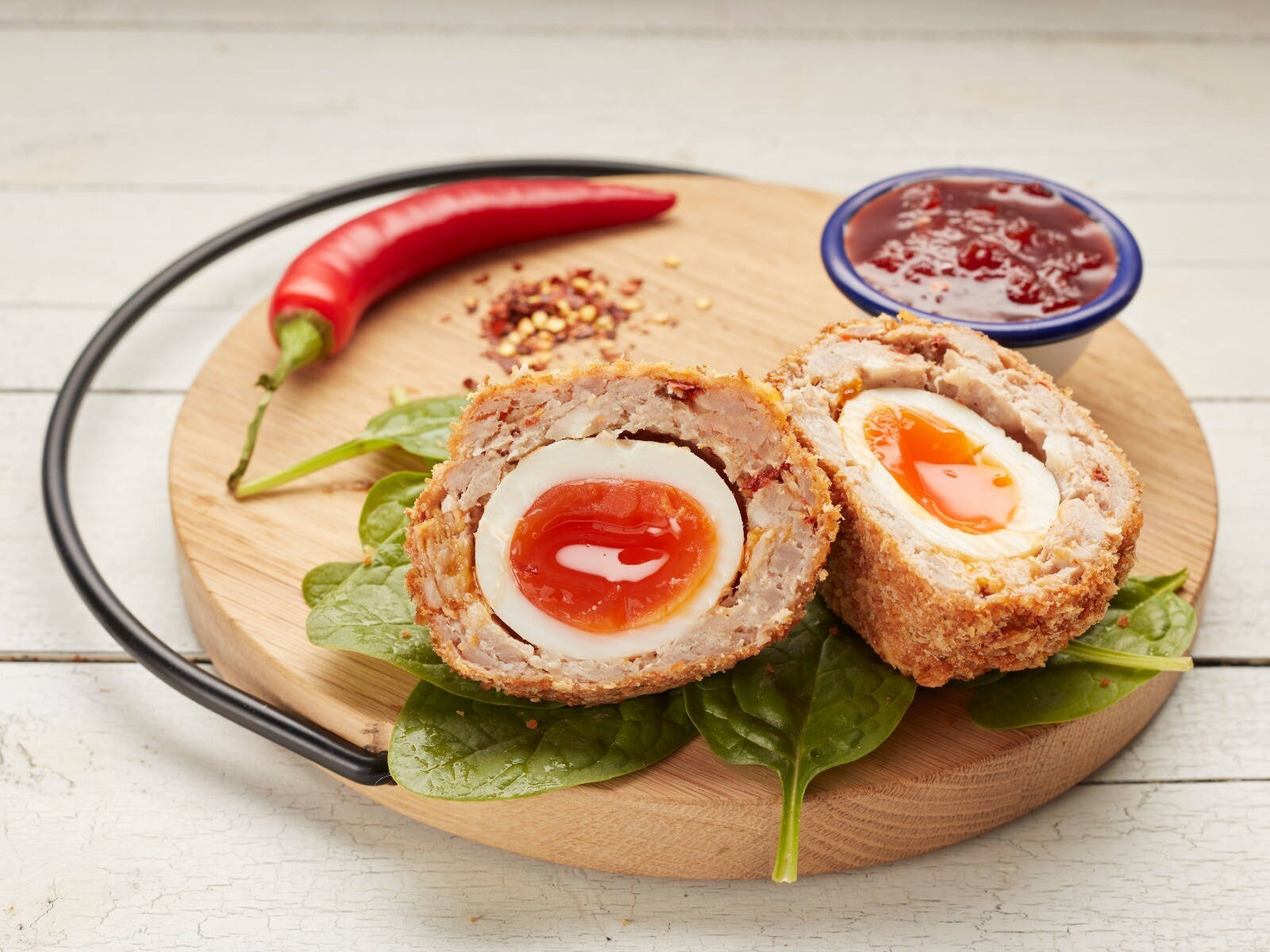 Scotch Egg Dish With Spinach And Chili Sauce Background