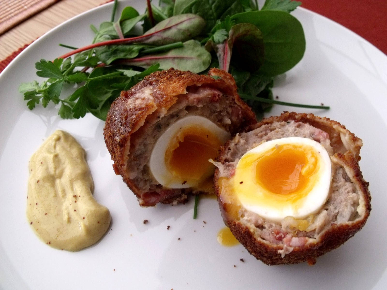 Scotch Eggs Dish With Spinach And Creamy Sauce