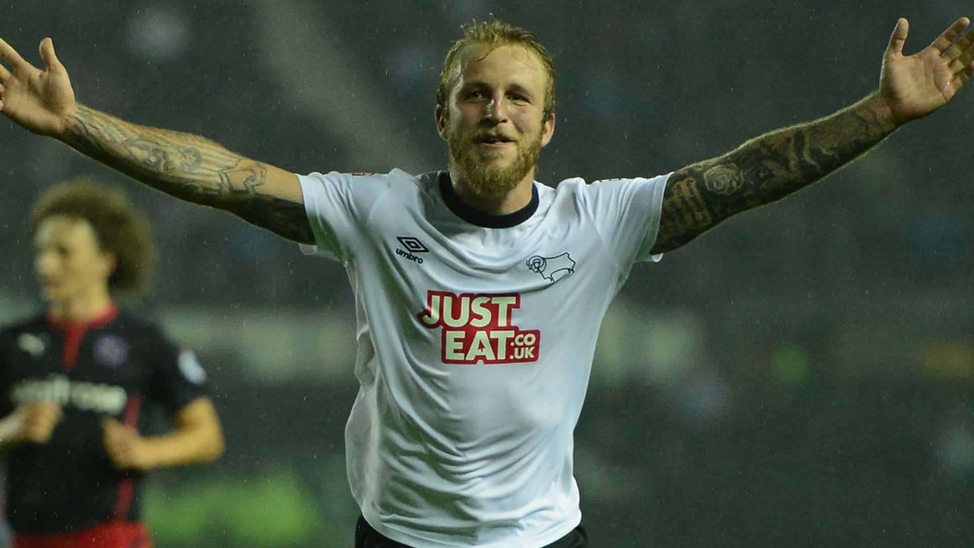 Scottish Professional Football Player Johnny Russell On Field Background