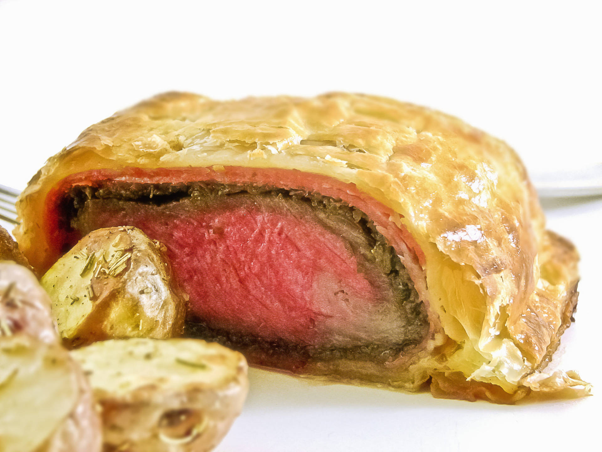 Scrumptious Beef Wellington With A Side Of Garlic Bread Background