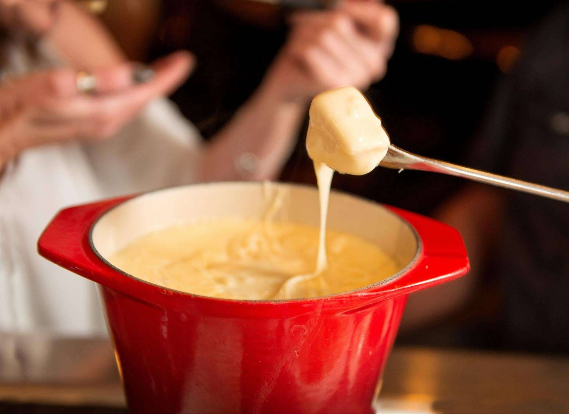 Scrumptious Cheese Fondue In A Red Pot