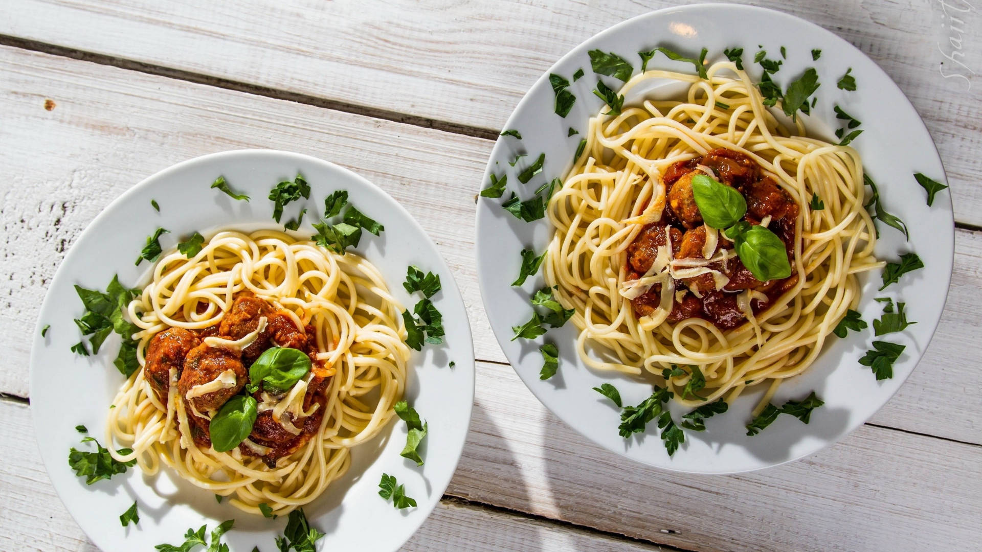 Scrumptious Italian Pasta Served On Two Plates Background