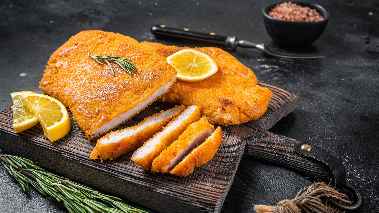 Scrumptious Wiener Schnitzel Served With Lemon Wedges And Parsley Garnish Background