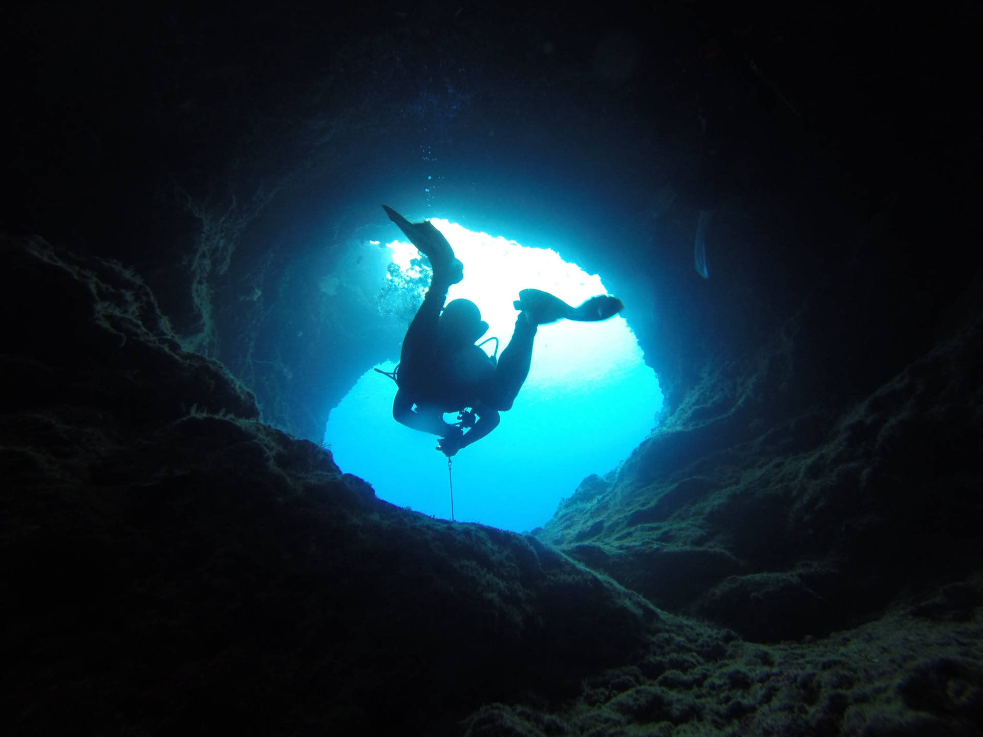 Scuba Diving Out Narrow Cave Background