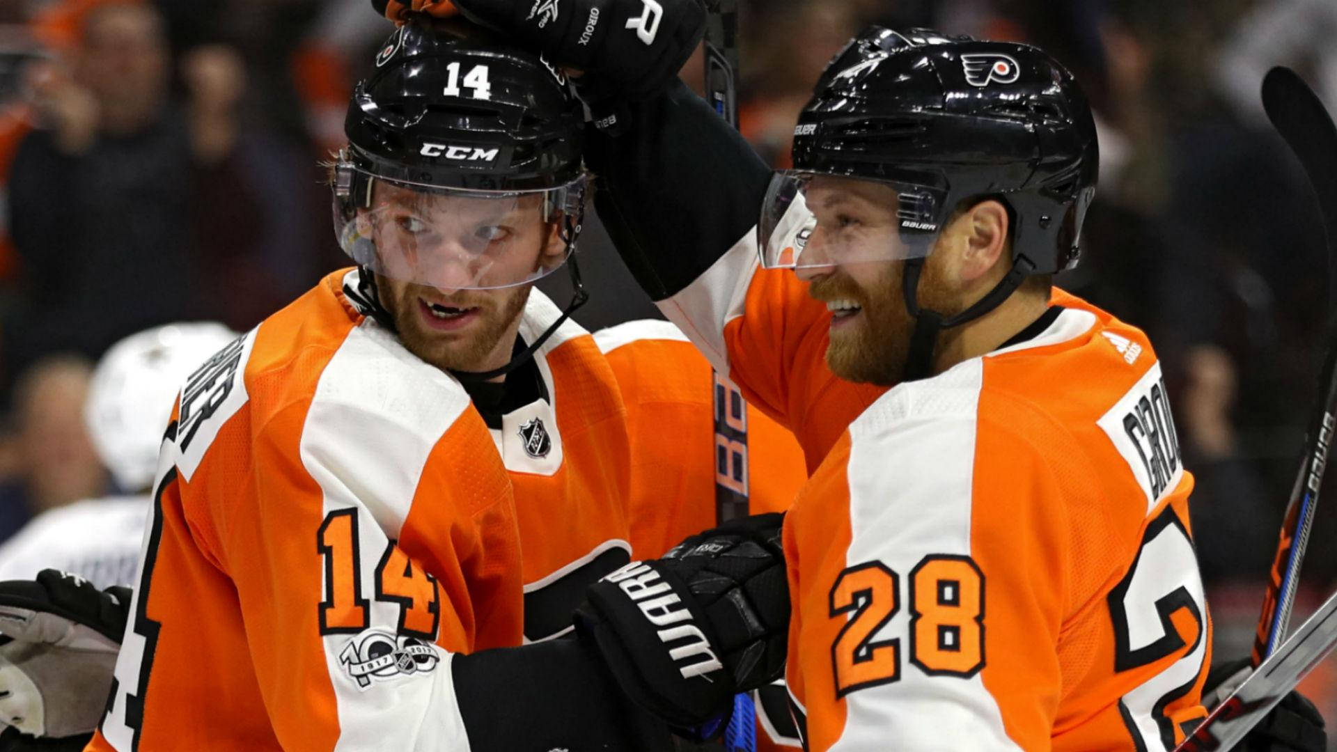 Sean Couturier Celebrating A Victory With Teammate Background