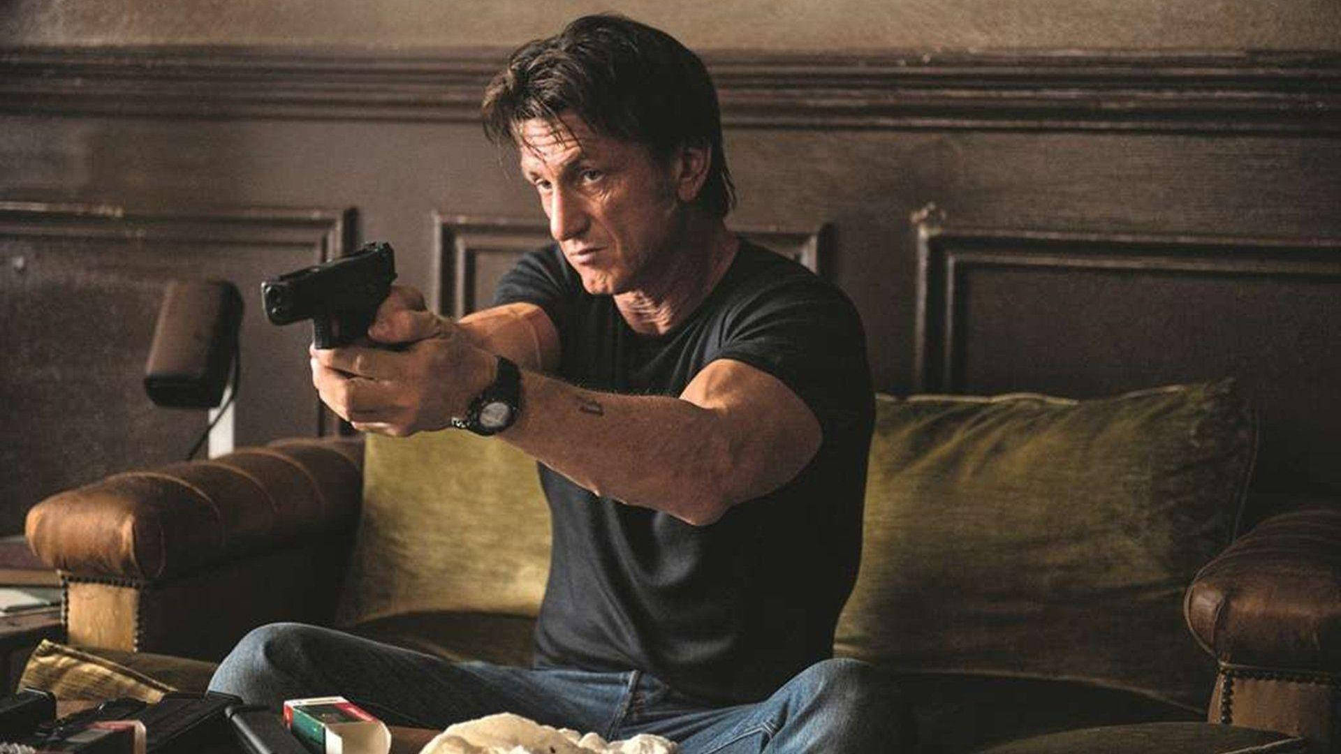 Sean Penn Holding A Gun Background