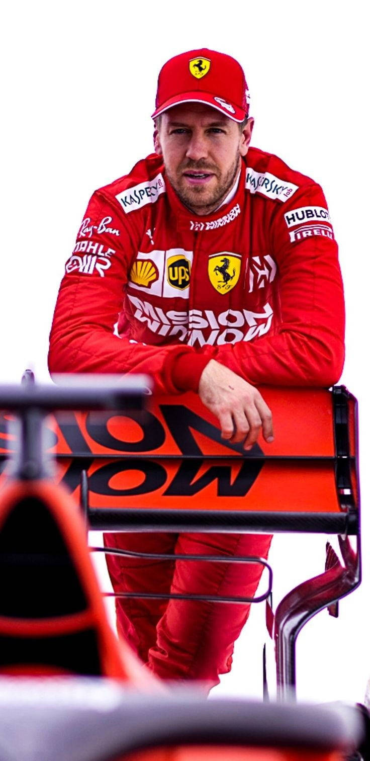Sebastian Vettel Leaning On A Rail Background