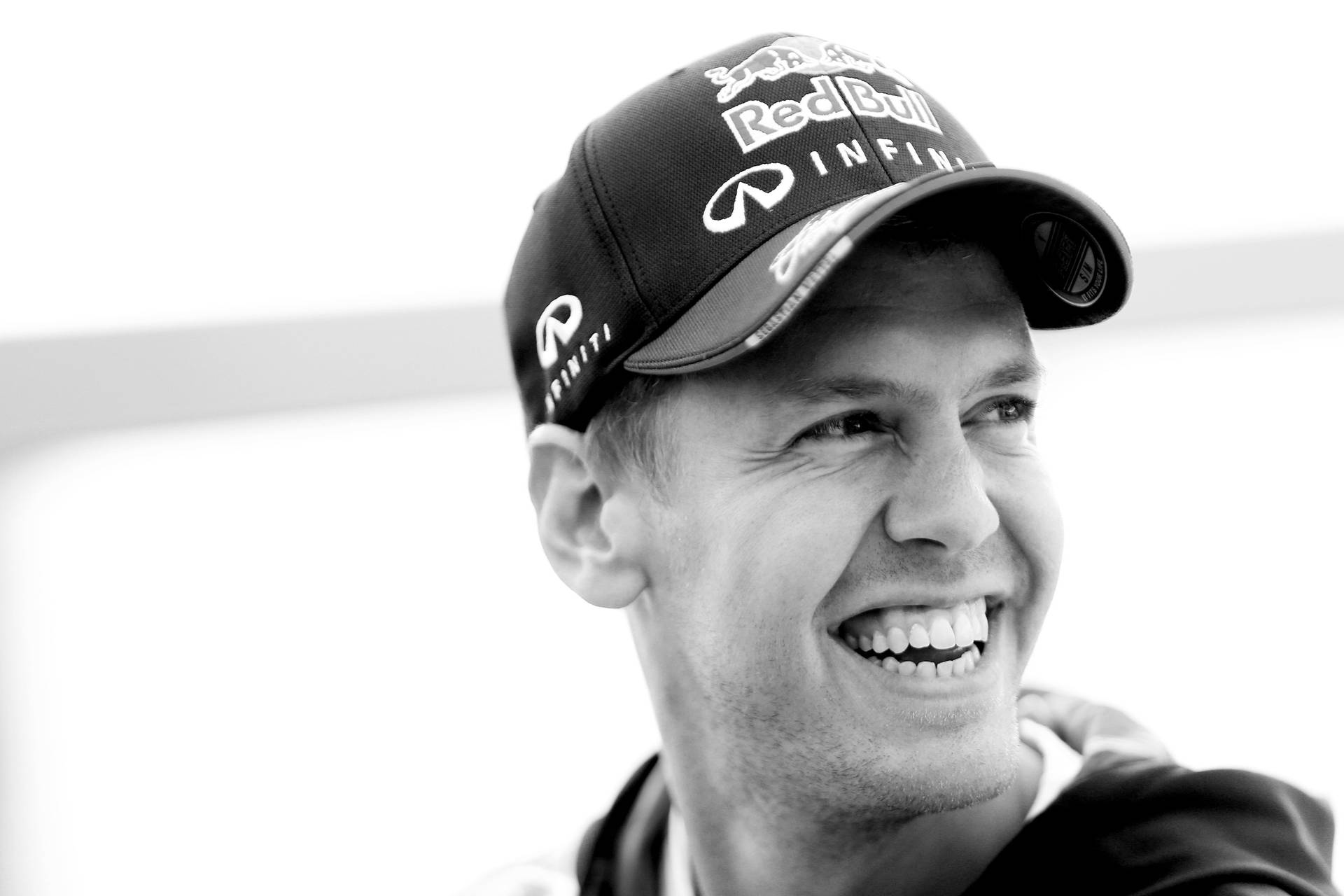 Sebastian Vettel Smiling Brightly Background