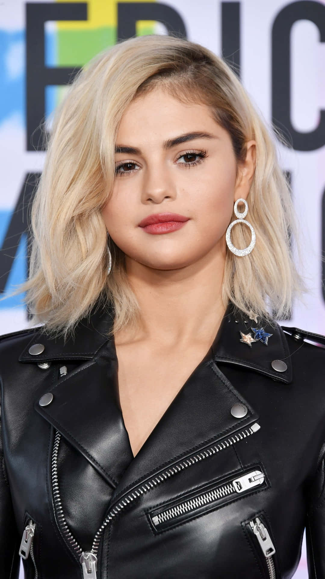 Selena Gomez Poses With Her Iphone Background