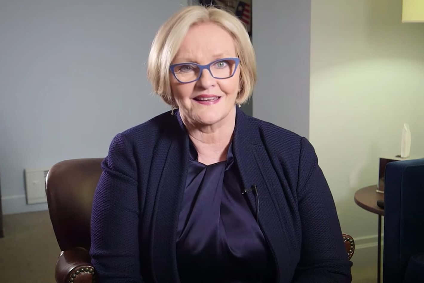 Senator Claire Mccaskill Sitting On An Armchair Background