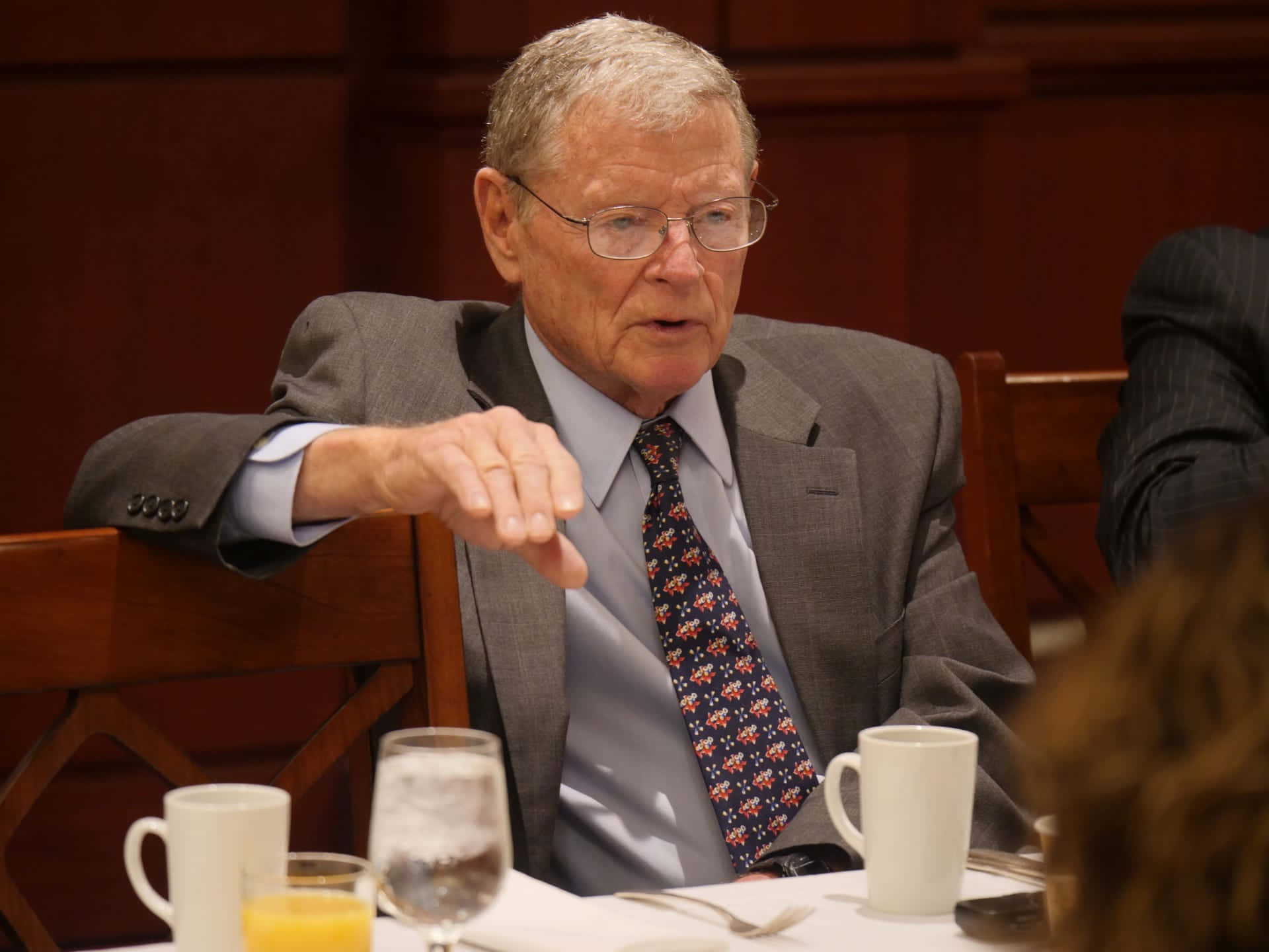 Senator Jim Inhofe Seated At A Table During A Discussion Background
