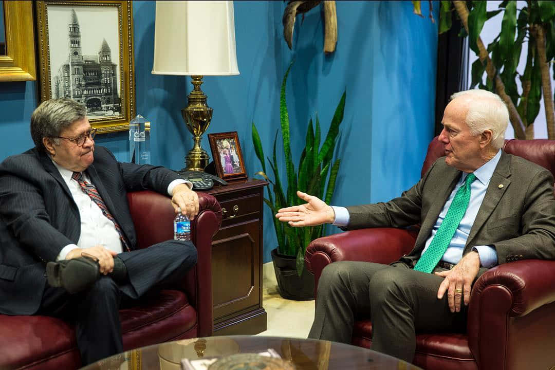 Senator John Cornyn Engaged In An Informal Discussion With A Colleague