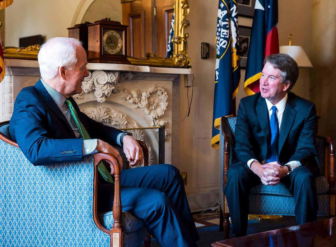 Senator John Cornyn In Dialogue With Colleague Background