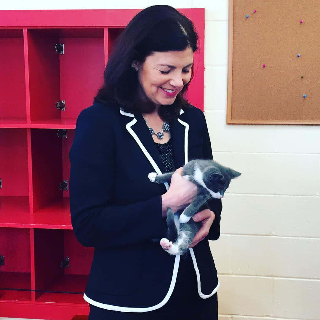 Senator Kelly Ayotte Playing With A Loving Cat. Background