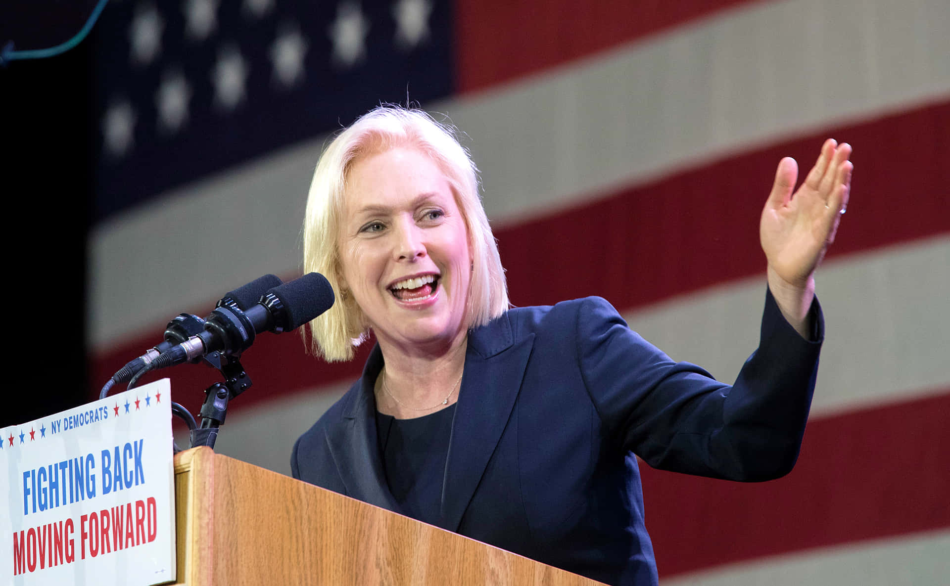 Senator Kirsten Gillibrand Extending Her Left Hand In A Gesture Of Engagement Background