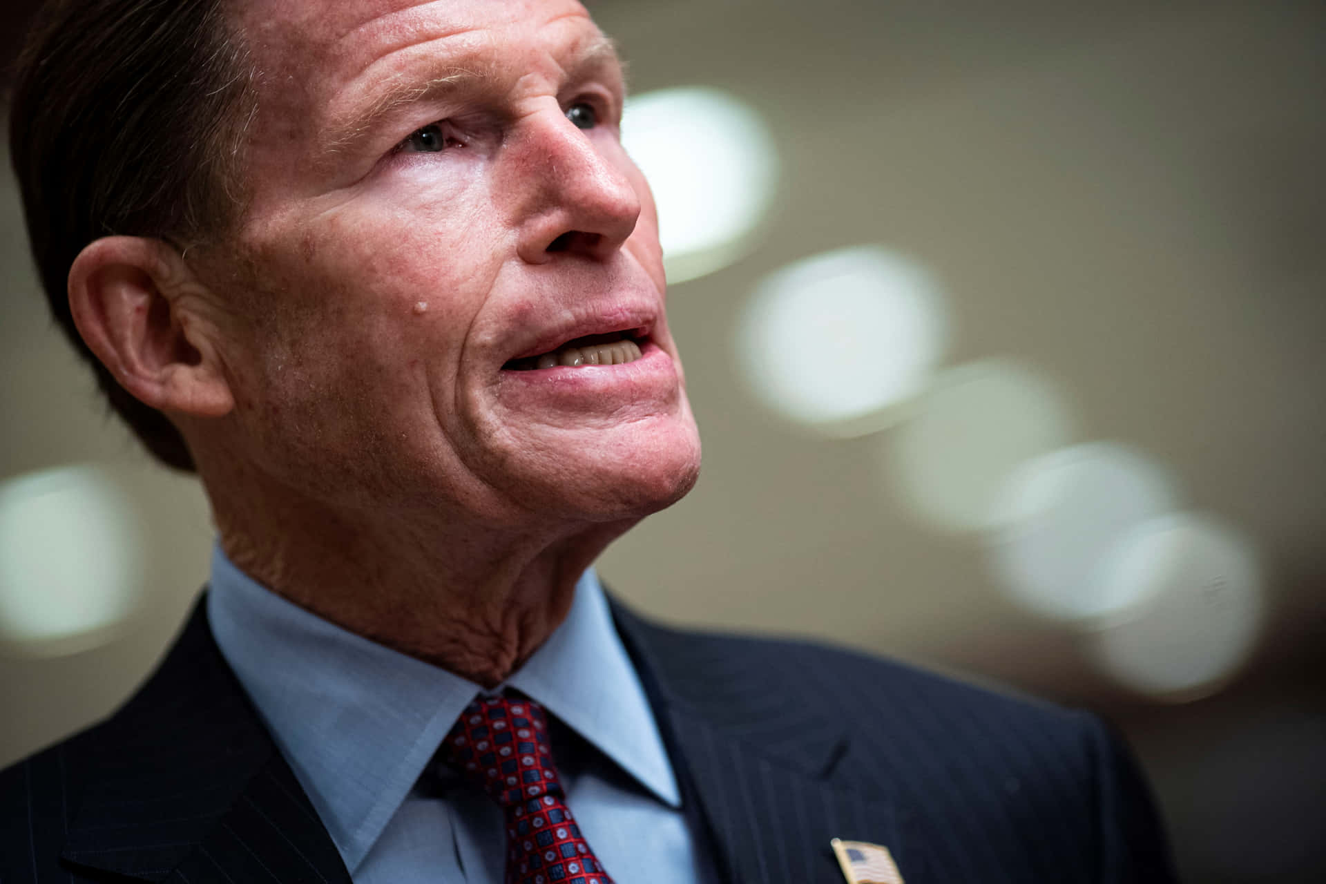 Senator Richard Blumenthal Delivering A Speech Against A Backdrop Of Bokeh Lights