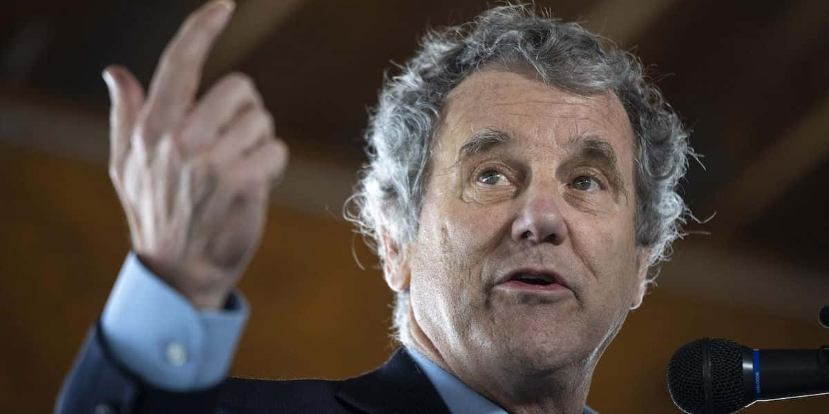 Senator Sherrod Brown Intensely Speaking During A Public Speech Background