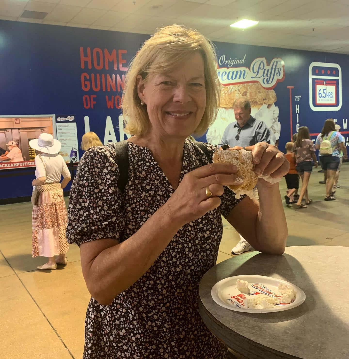 Senator Tammy Baldwin Enjoying A Cream Puff Background