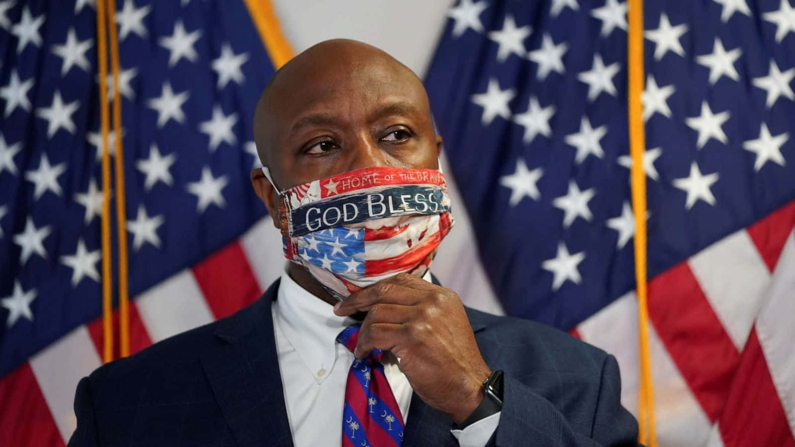 Senator Tim Scott Wearing A Patriotic 'god Bless America' Face Mask Background