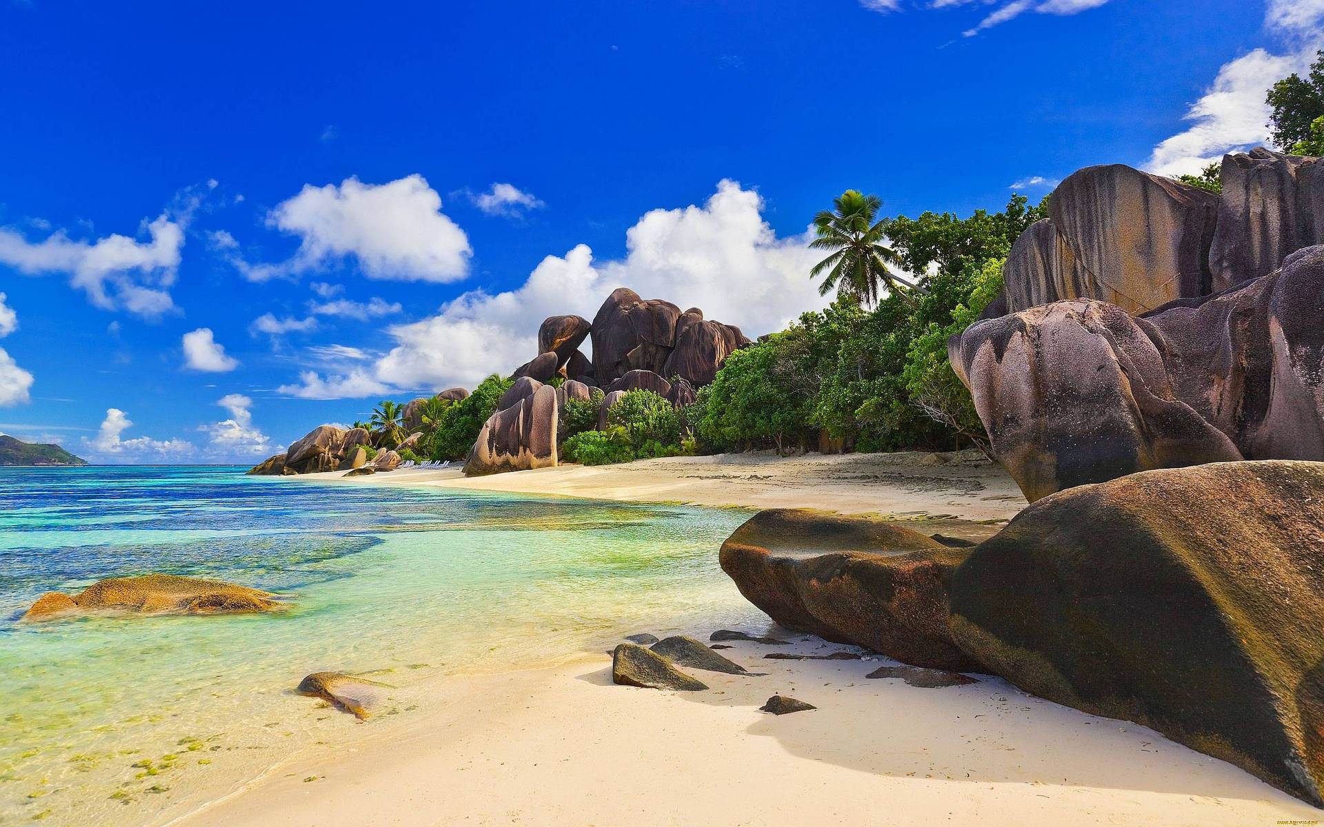 Serene Beach Landscape With Majestic Rock Formations Background