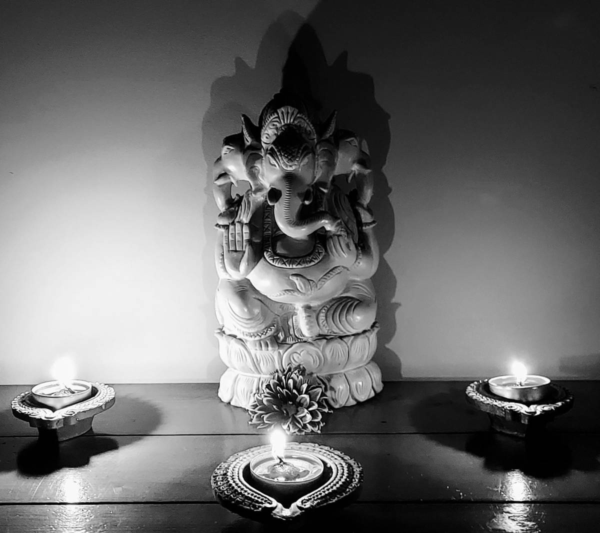 Serene Black And White Illustration Of Ganesh Amidst Glowing Candles Background