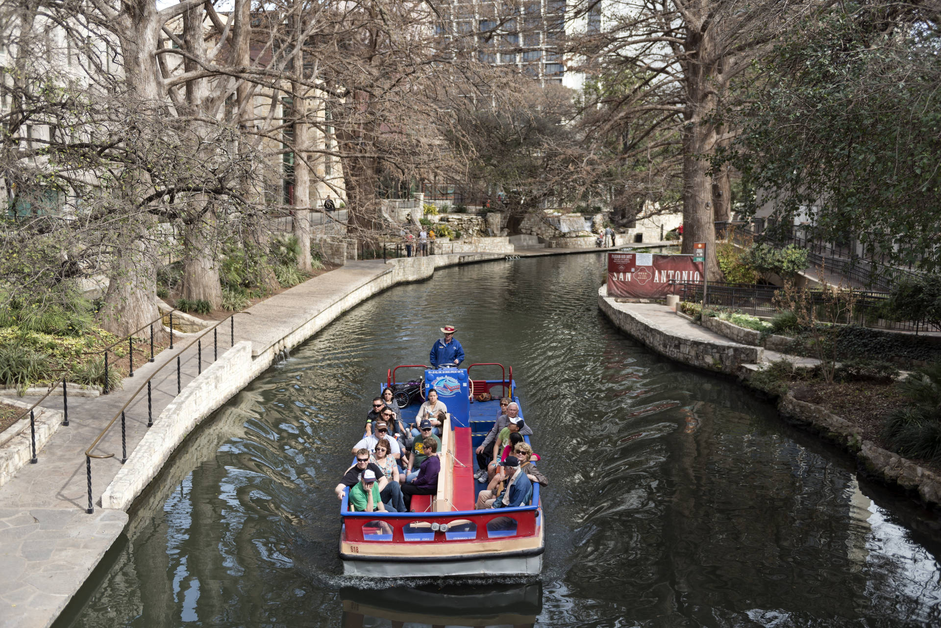 Serene Boat Tour On The San Antonio River Walk Background