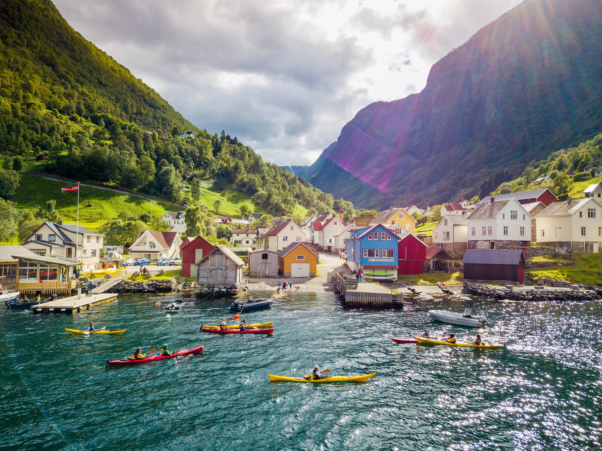 Serene Kayaking Adventure In Friendly Town Background