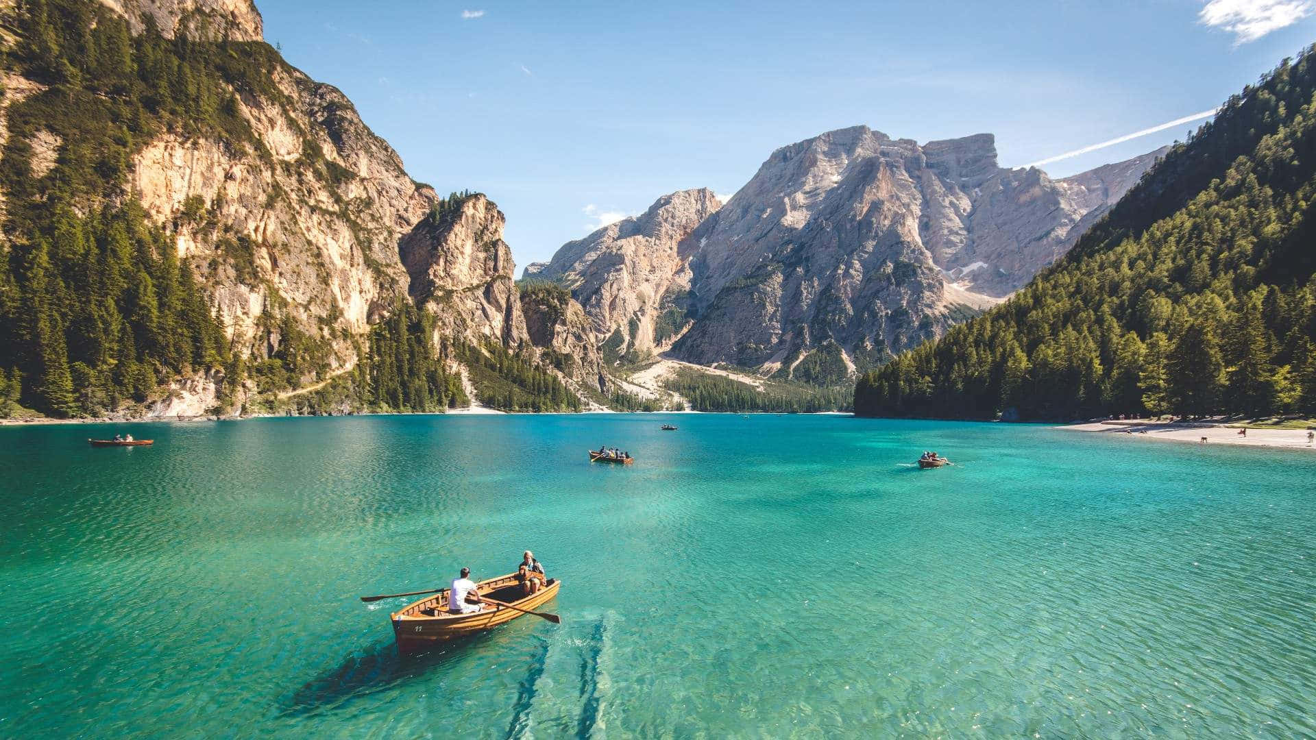 Serene_ Mountain_ Lake_ Boating_ Adventure Background