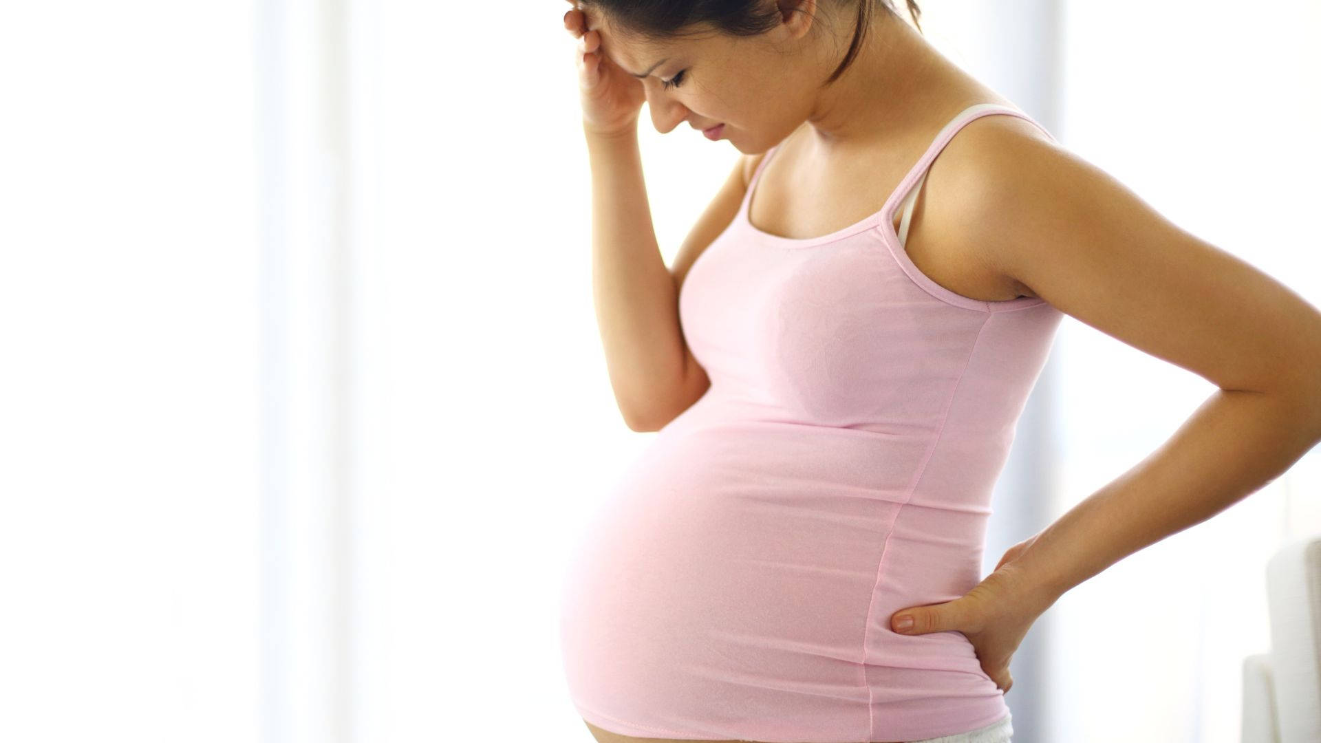 Serene Pregnant Woman Enjoying A Moment Of Peace Background