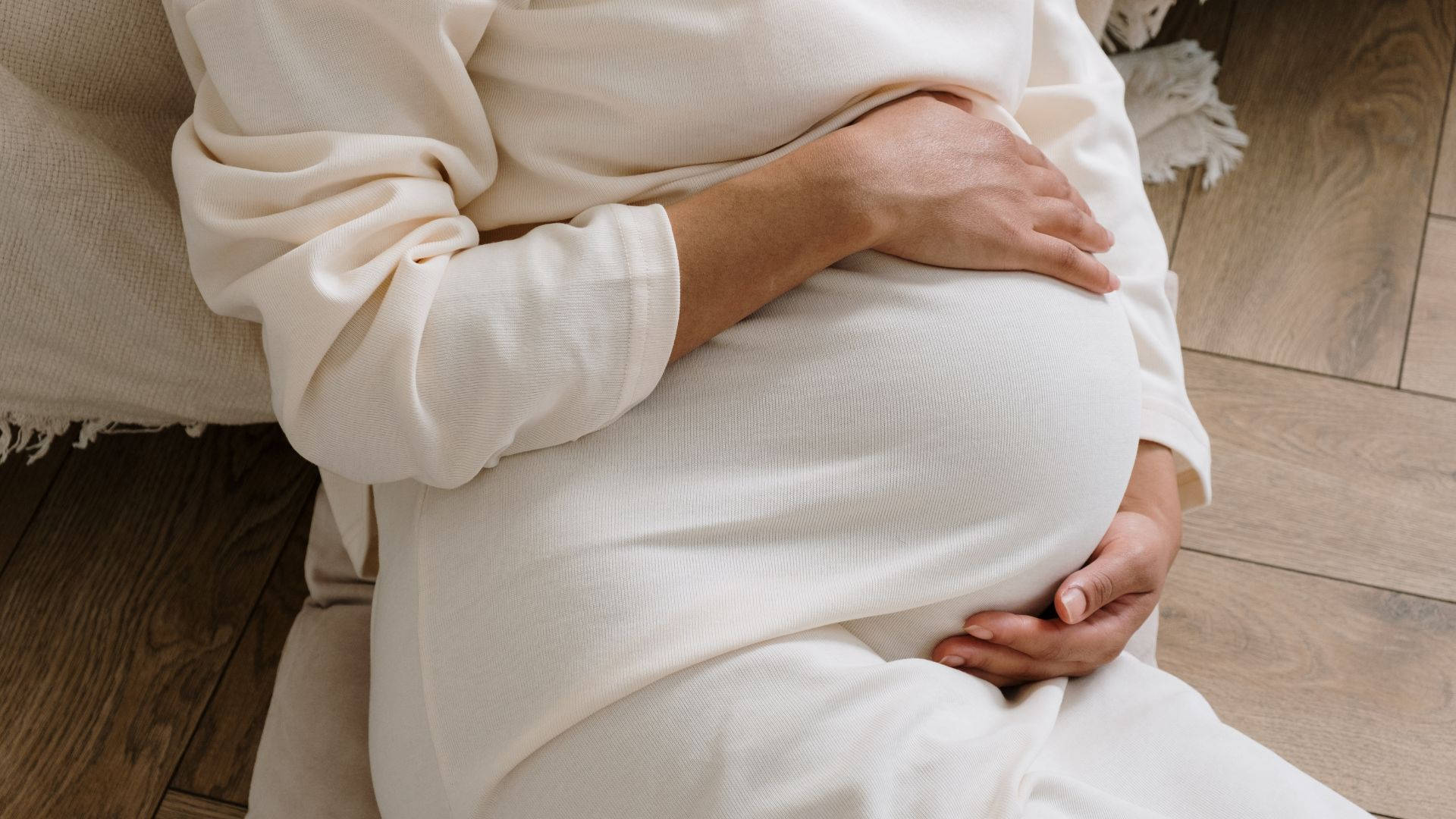 Serene Pregnant Woman In White Attire