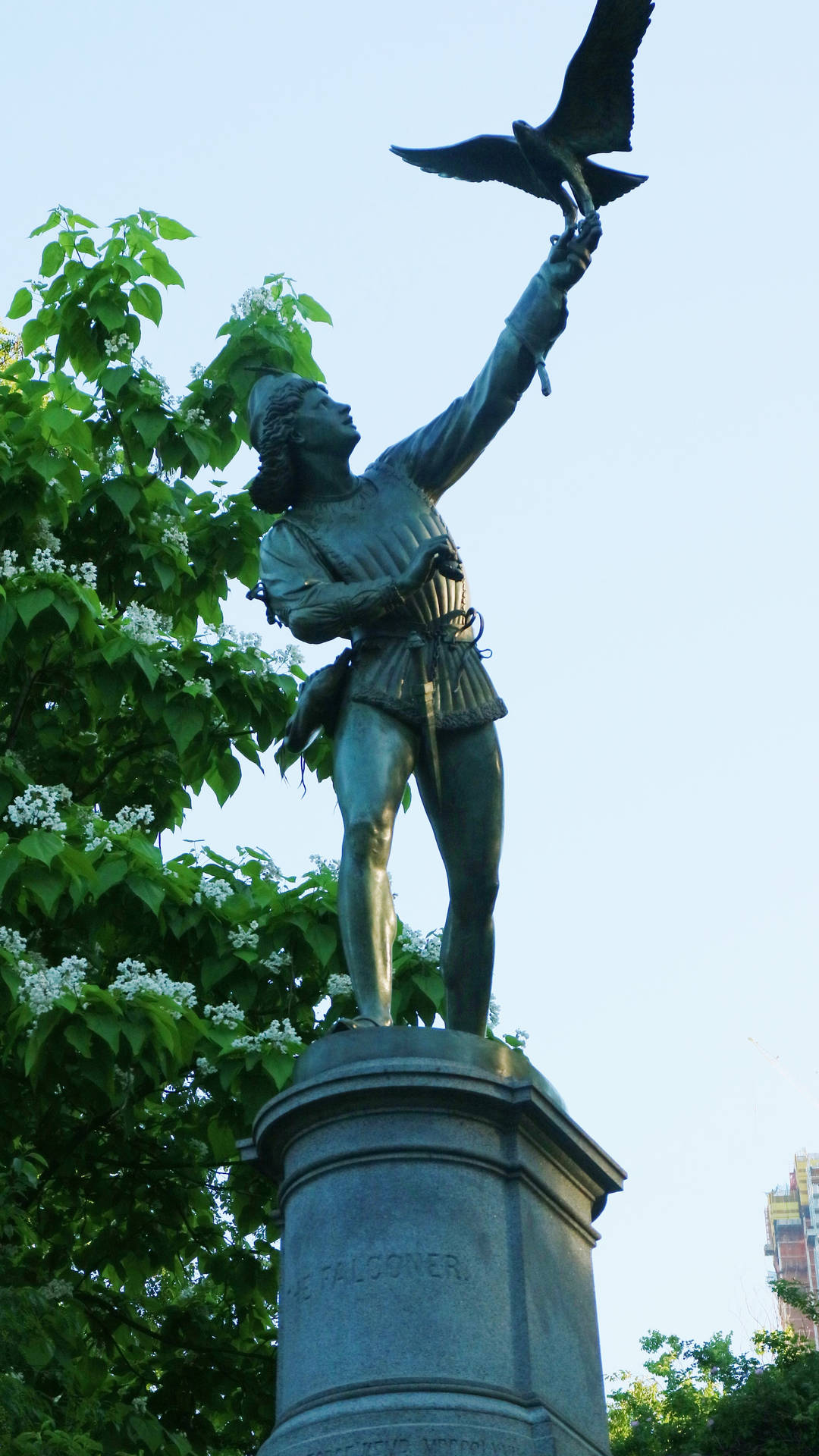 Serene Statue Amidst Nature In Central Park Background