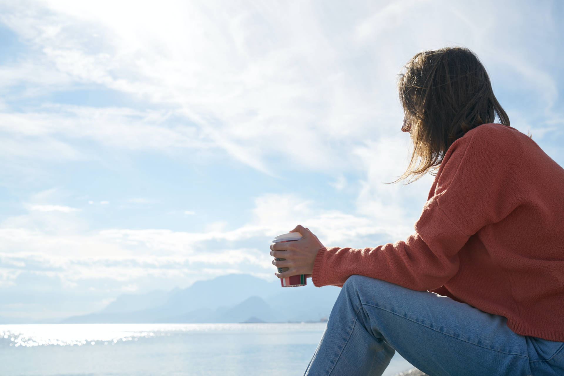 Serene Woman Enjoying Coffee In Solitude Background