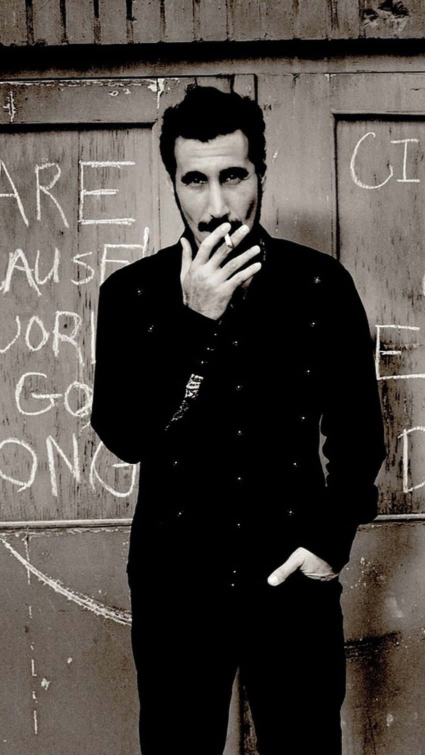 Serj_ Tankian_ Smoking_by_ Wall Background