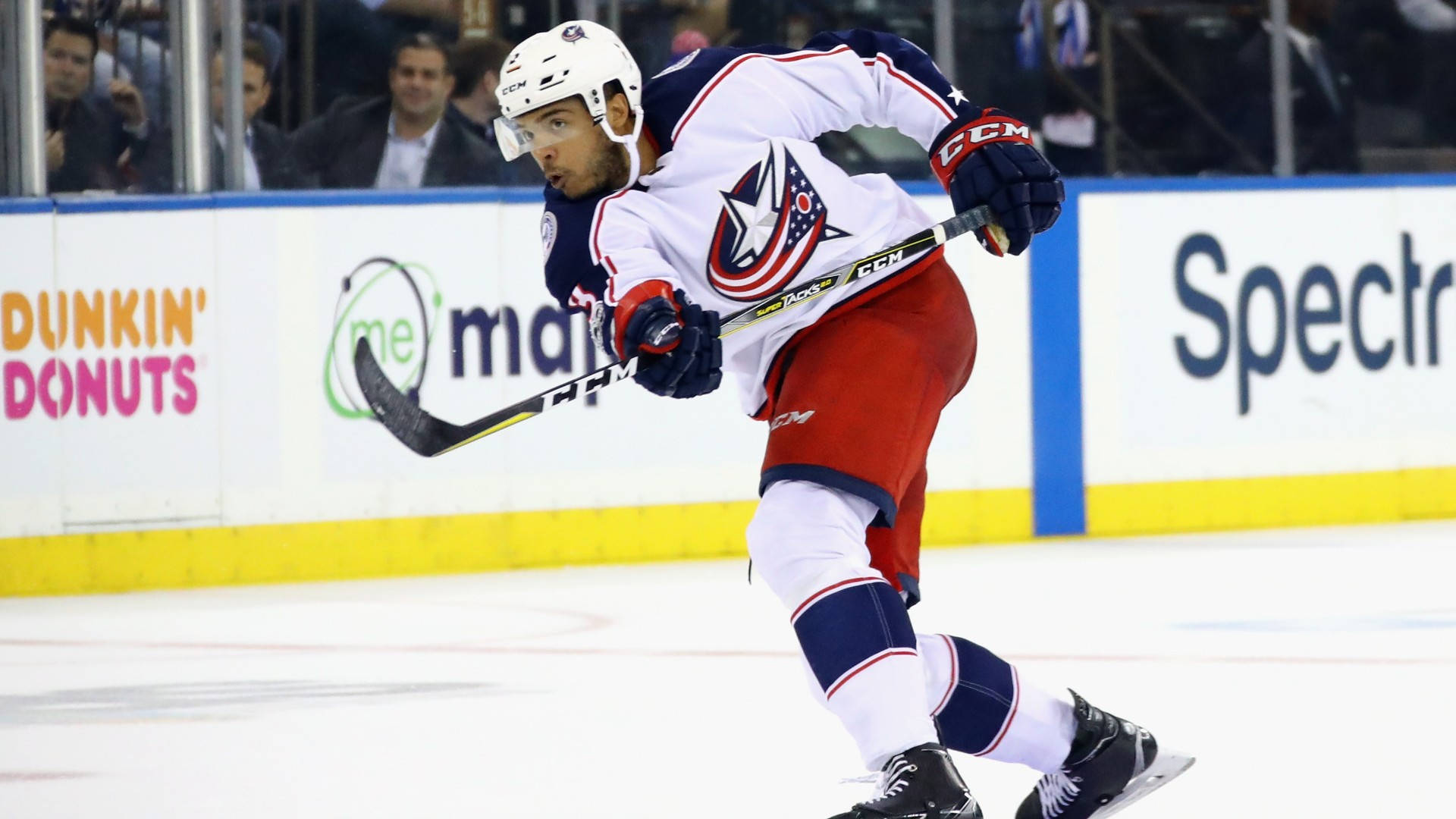 Seth Jones Gliding On Ice While Waving Hockey Stick Background