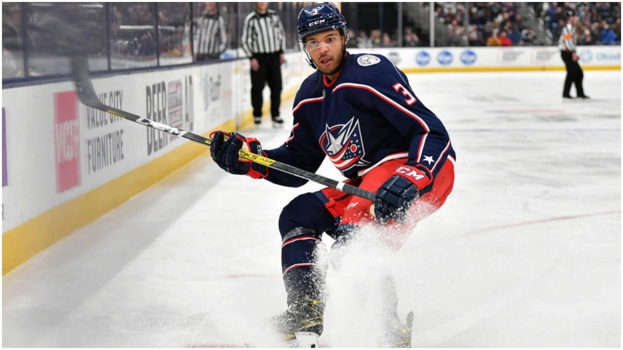 Seth Jones Gliding On Rink And Splashing Ice Background