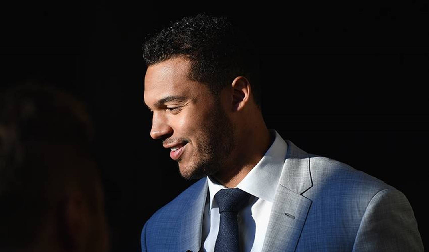 Seth Jones Wearing Formal Tie Suit And Smiling In The Spotlight Background