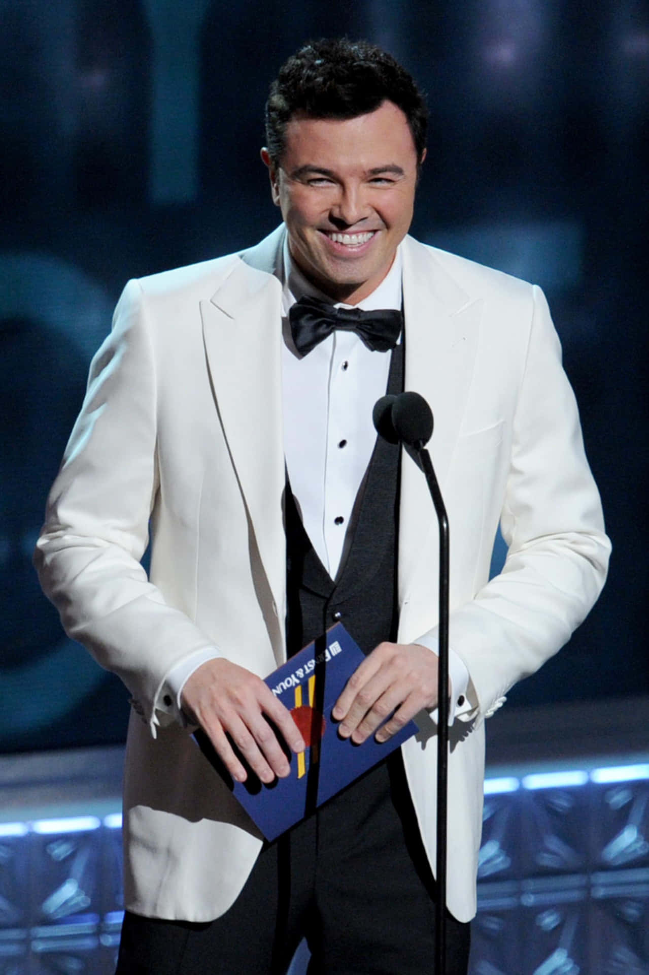 Seth Macfarlane Looking Suave Against A Sharp Backdrop Background