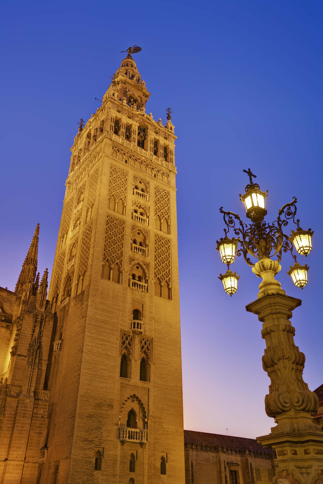 Seville Cathedral Bell Tower At Sundown Background