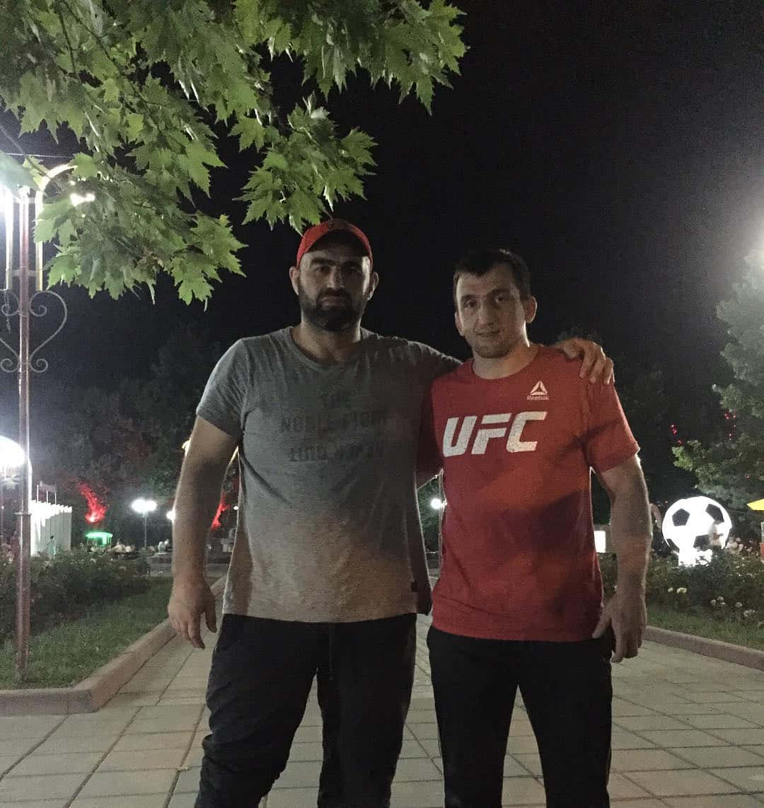 Shamil Abdurakhimov With Man In Ufc Shirt Background