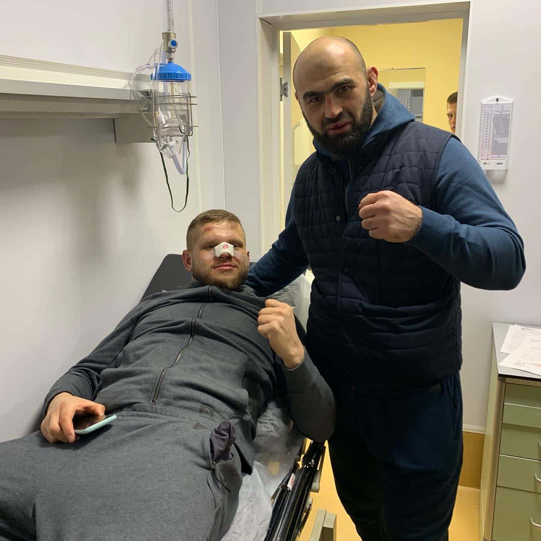 Shamil Abdurakhimov With Marcin Tybura On Stretcher Background