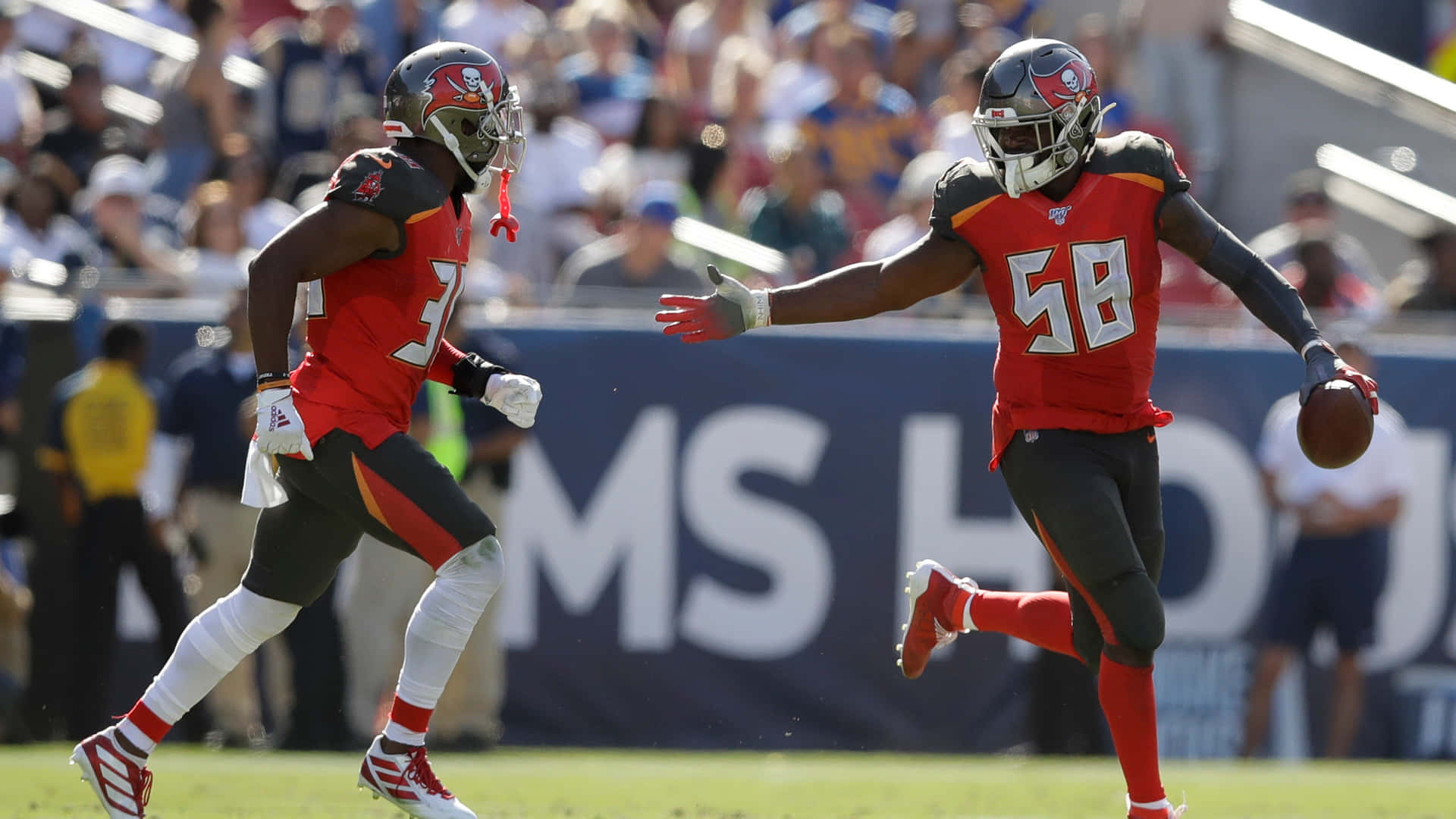 Shaquil Barrett Carrying The Football Nfl Background