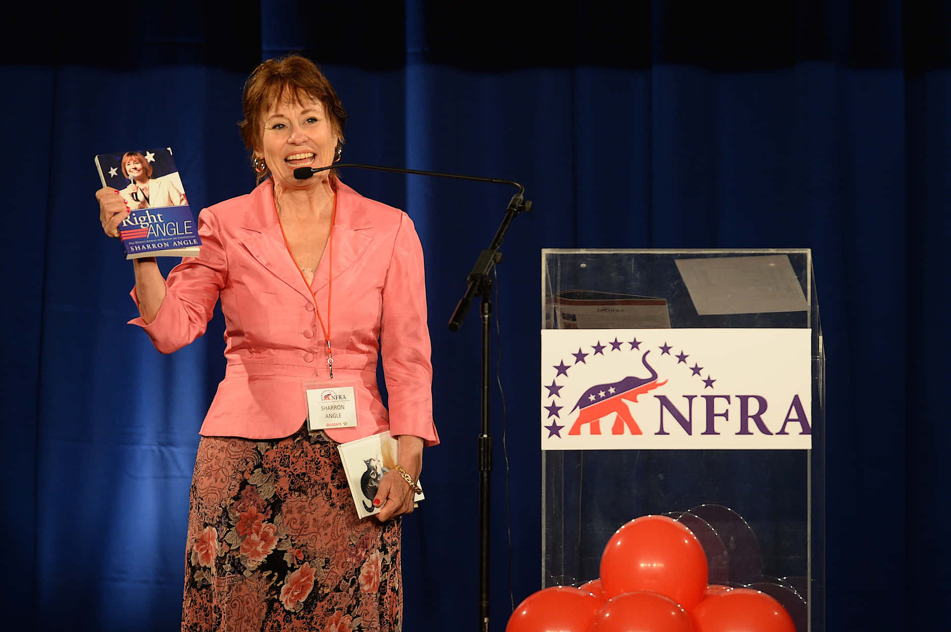 Sharron Angle On Stage With Book Background