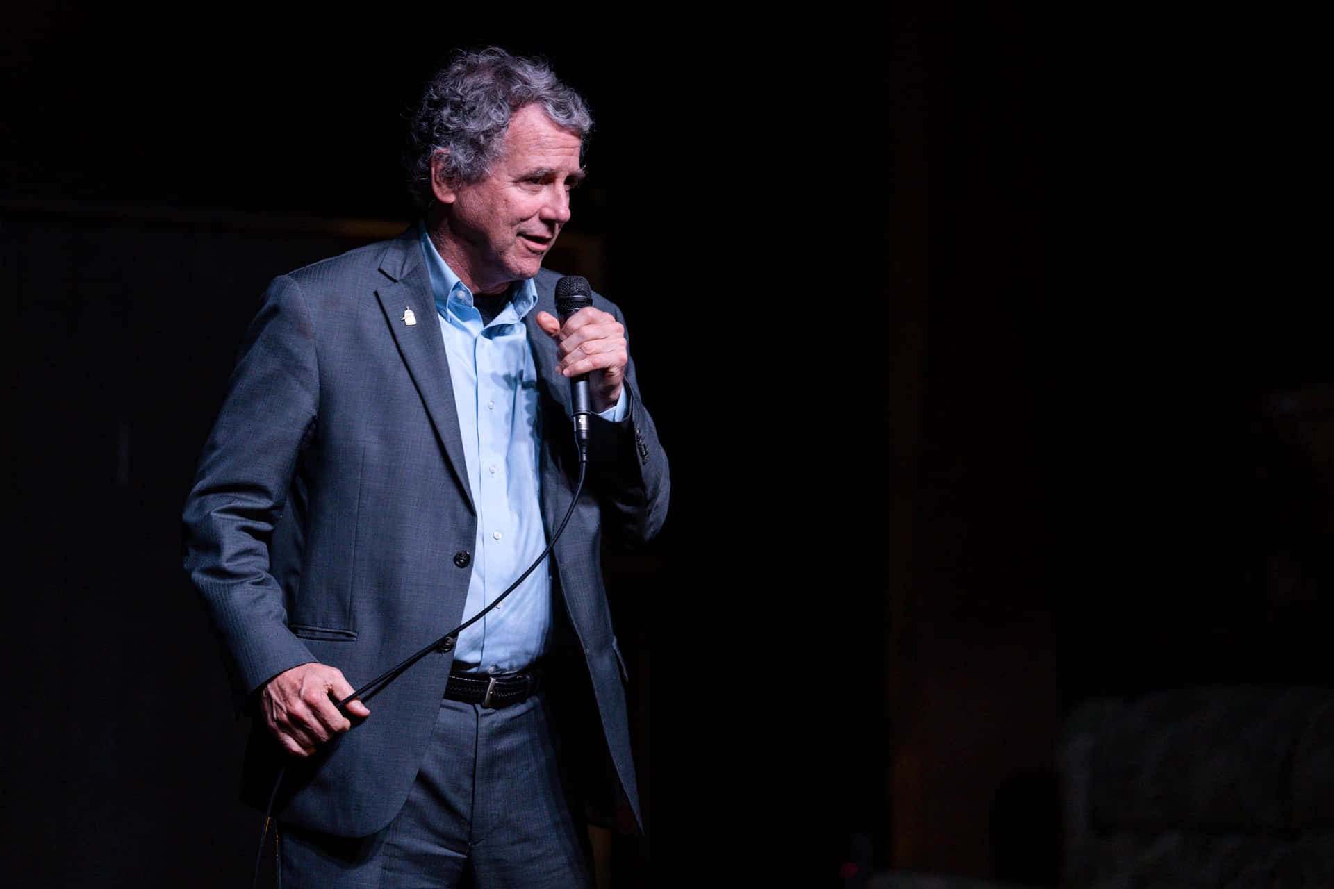 Sherrod Brown Addressing The Public With A Wired Microphone. Background