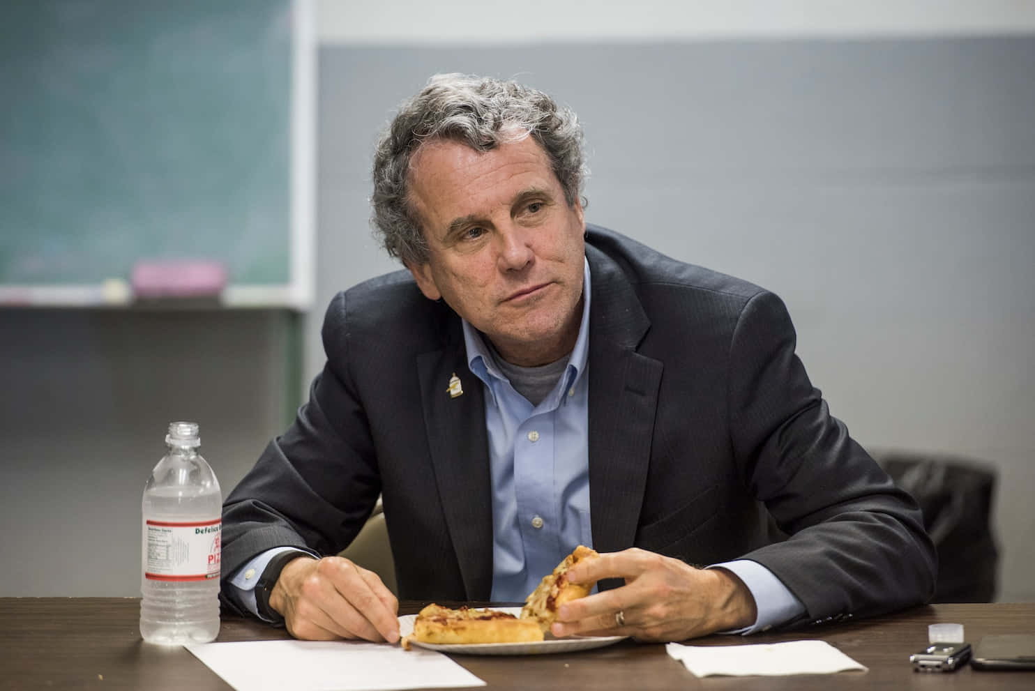 Sherrod Brown Eating Pizza Background