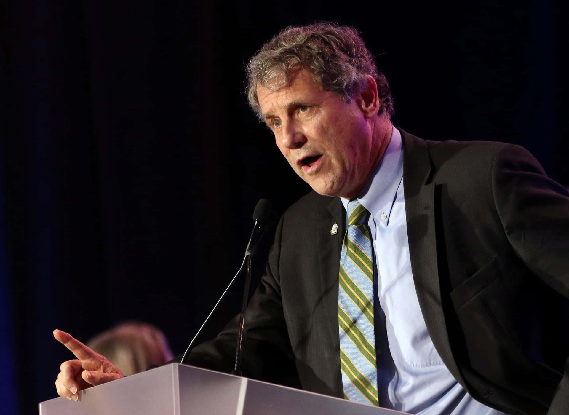 Sherrod Brown Leaning Into Speech Background