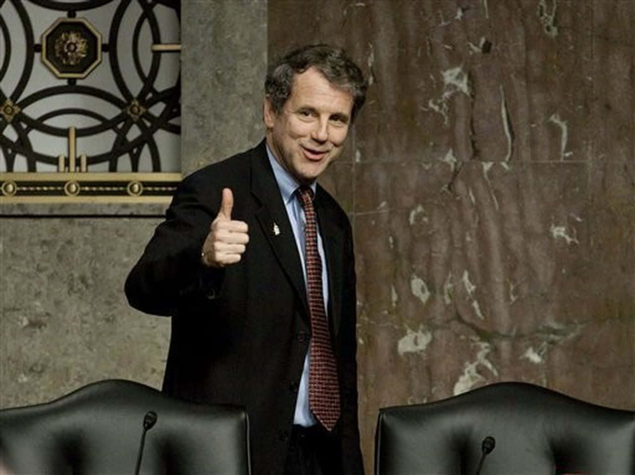 Sherrod Brown Offering A Thumbs Up Background